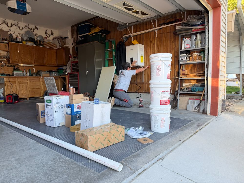 Paragon plumber mounting a wall-hung boiler in a residential garage